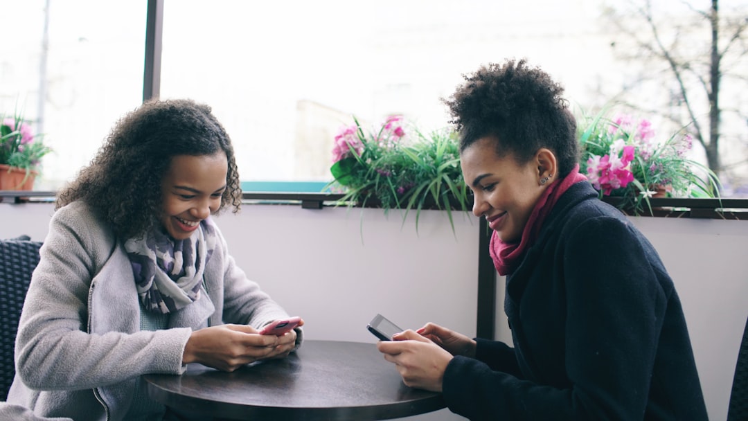 couple holding hands cafe smartphone