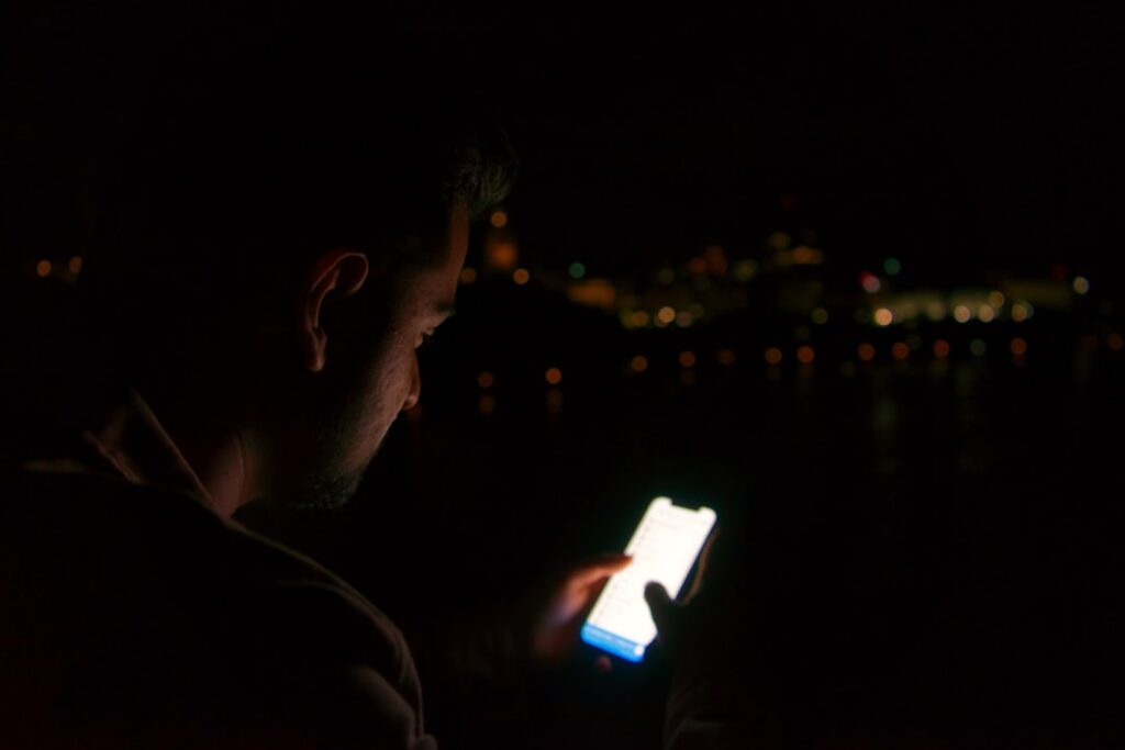 anxious man checking phone night