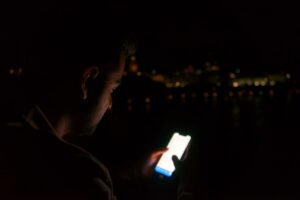 anxious man checking phone night