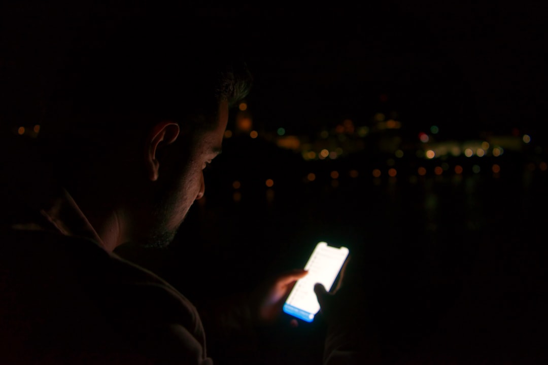 anxious man checking phone night
