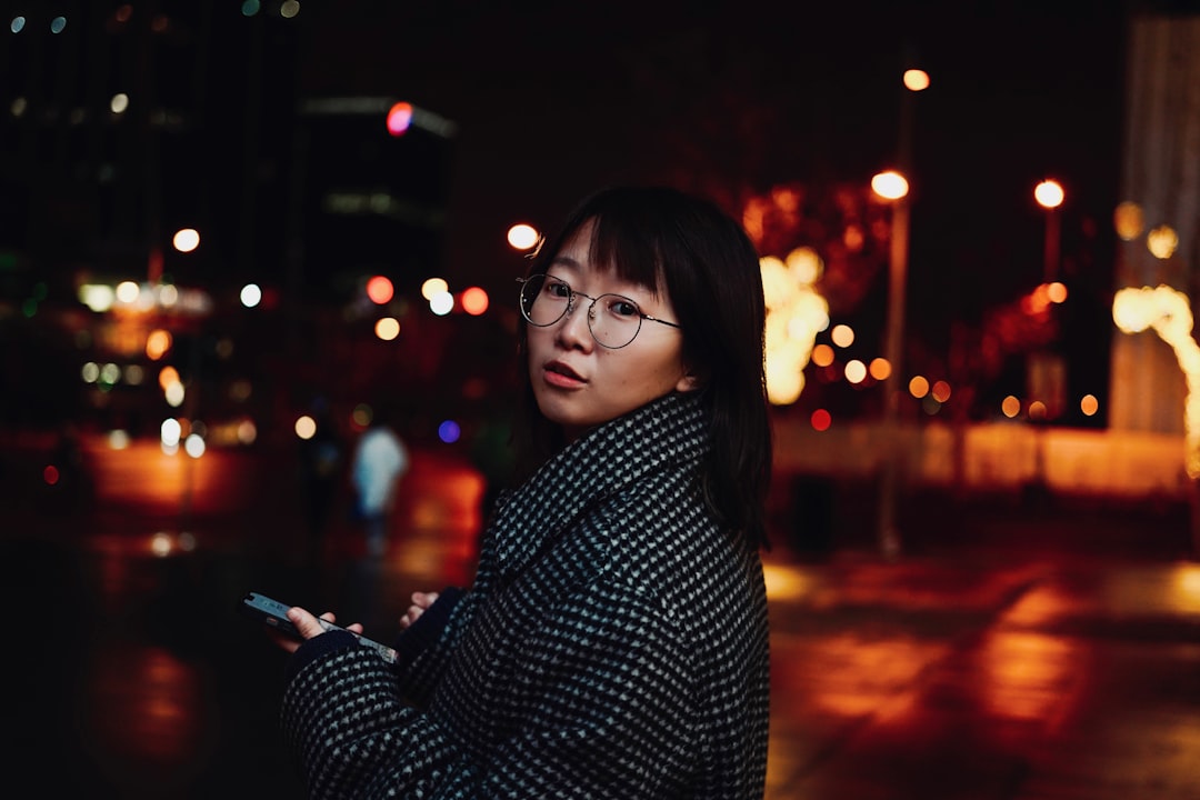 japanese woman thinking smartphone night serious