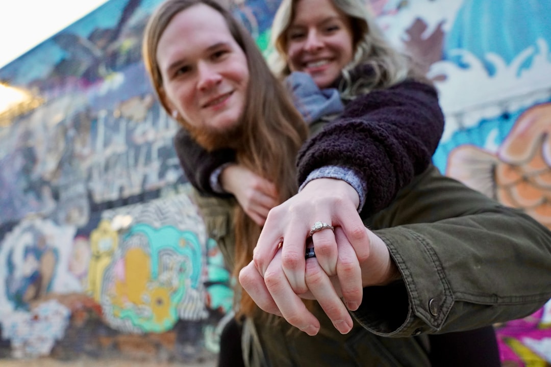 young couple engagement ring smiling