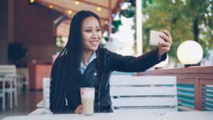 young japanese woman smartphone smile cafe