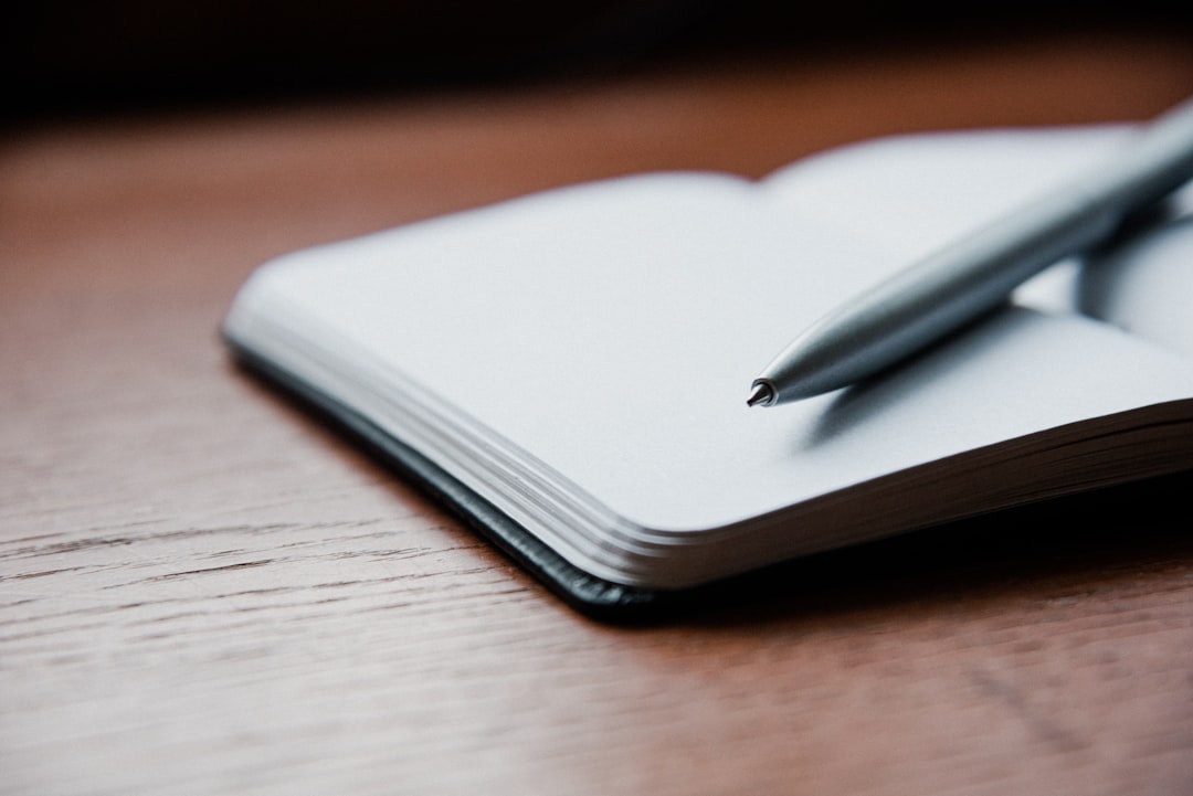 checklist notebook pen wooden desk