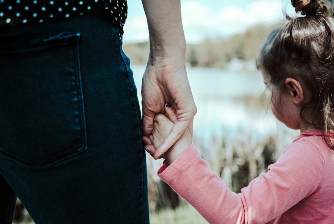 mother daughter holding hands park