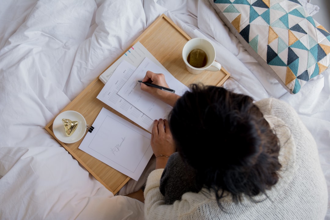 woman writing notebook to do list morning