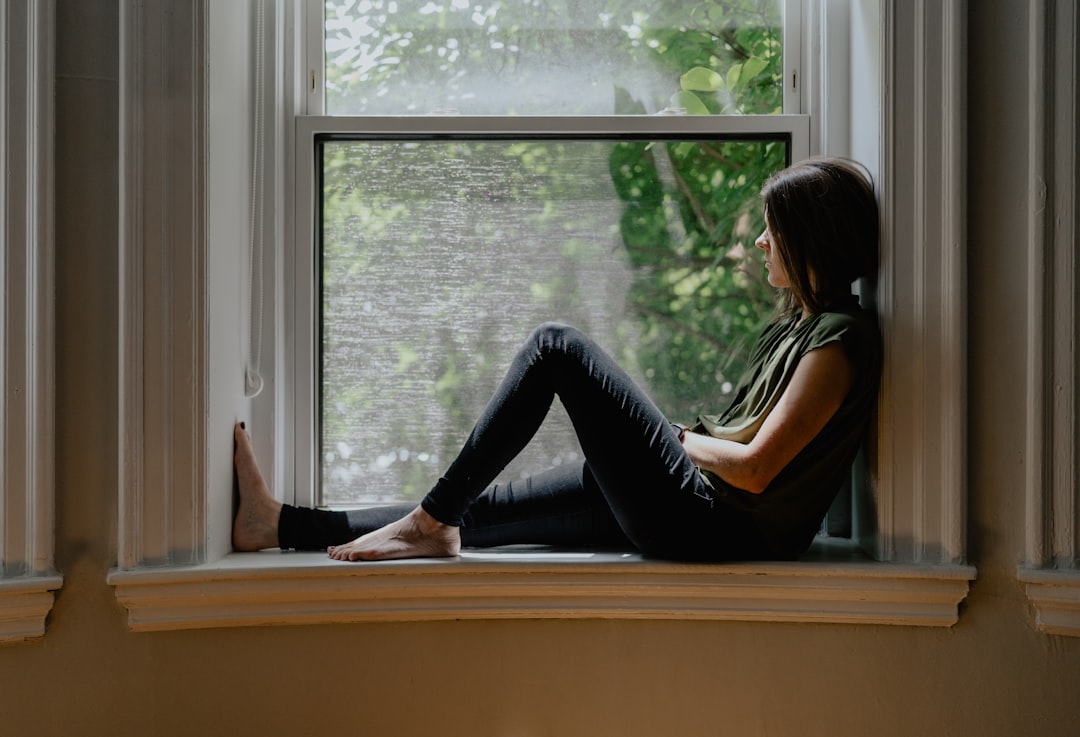 thoughtful woman window light