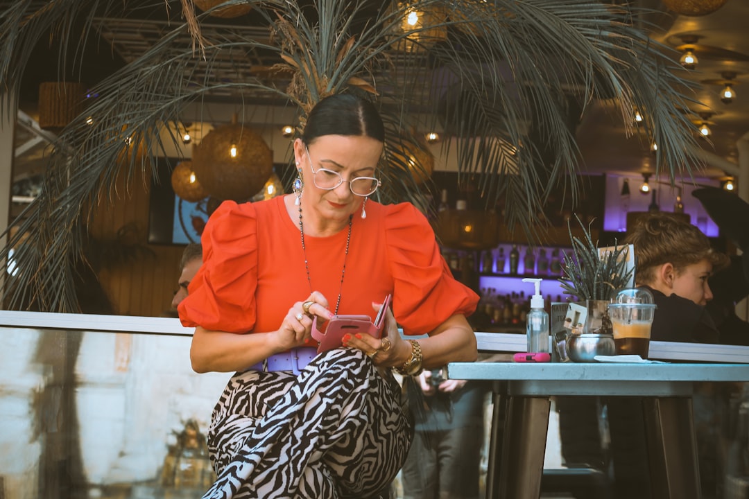 woman cafe smartphone evening