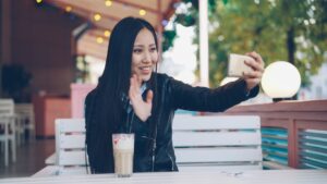 japanese woman late 20s smartphone cafe thinking