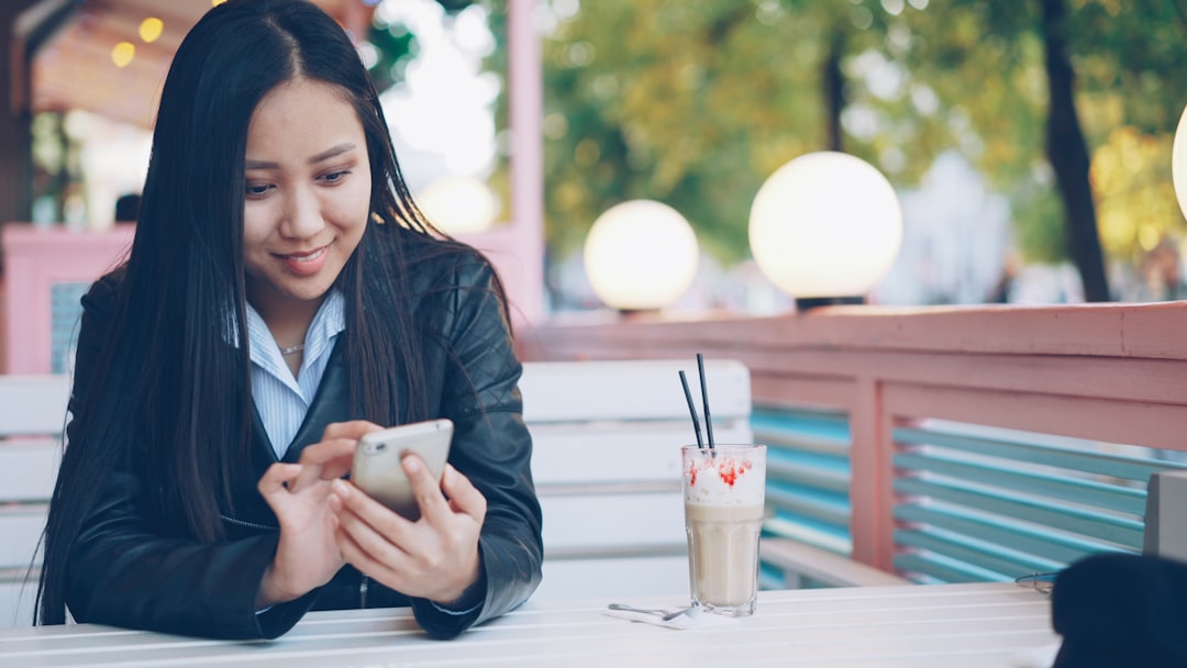 woman comparing options smartphone cafe