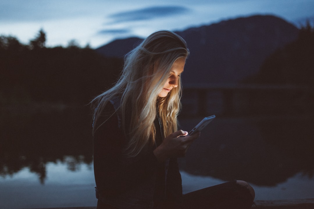 woman comparing dating apps smartphone night
