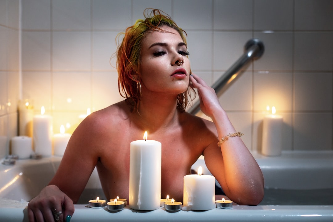 woman relaxing bath candles self care