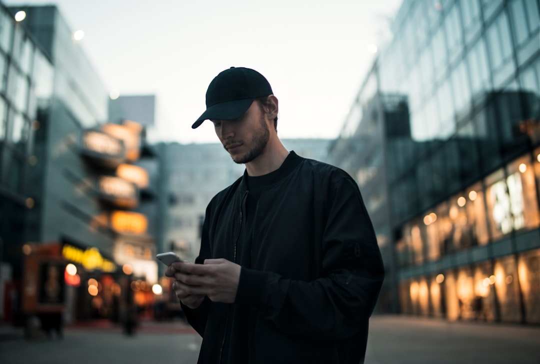 young man smartphone city