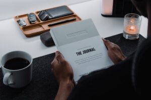 woman thinking journal coffee