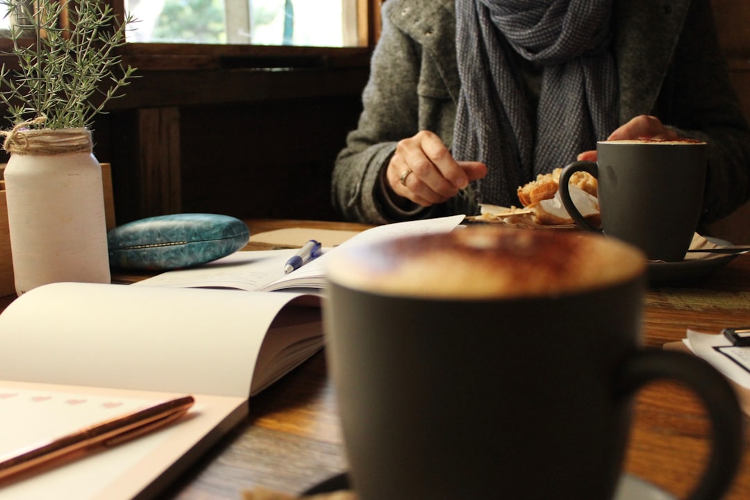 woman decision making notebook coffee