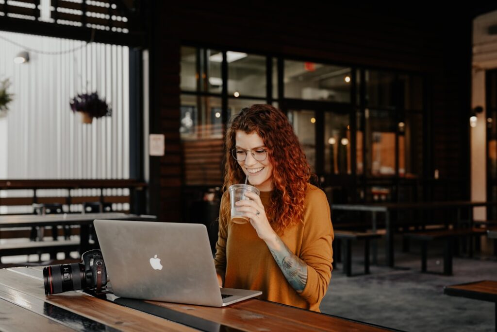 young woman thinking laptop coffee