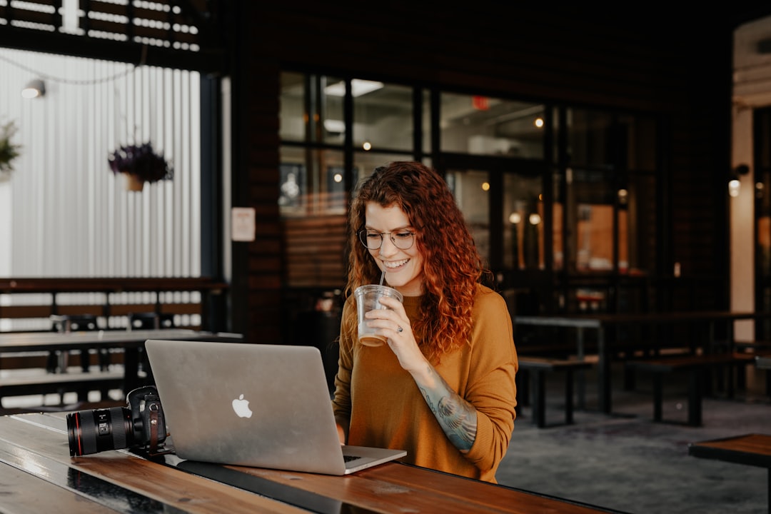 young woman thinking laptop coffee