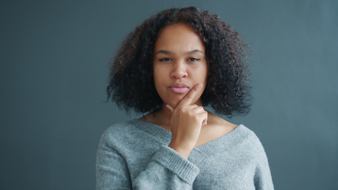 young woman thinking question mark