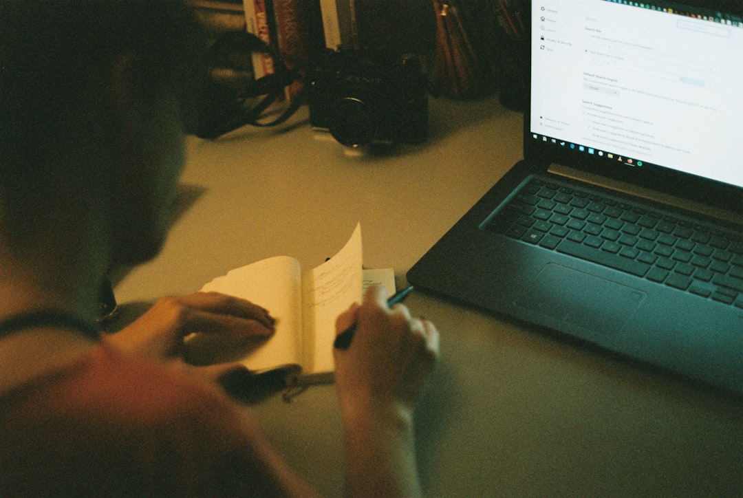person writing profile laptop