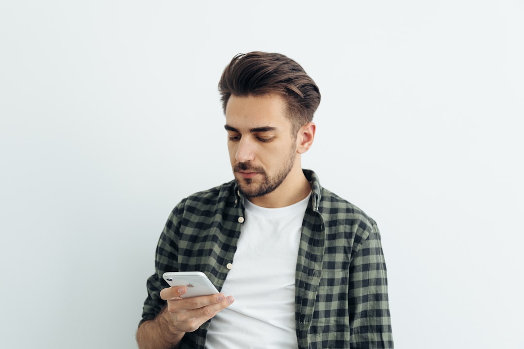 frustrated man looking at phone