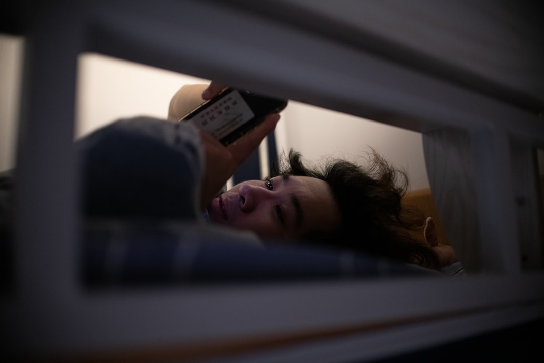 tired woman smartphone bed night