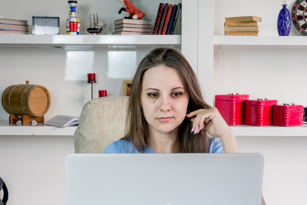 woman thinking worried laptop home