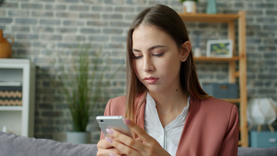 woman reading message phone cautious