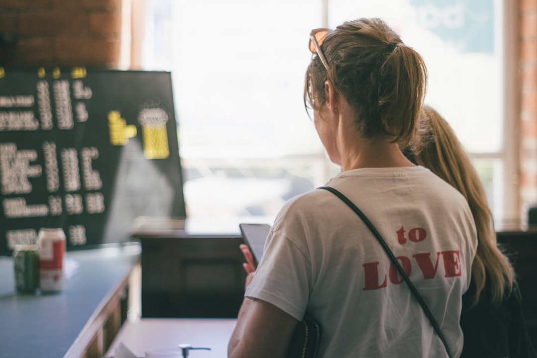 woman thinking smartphone cafe