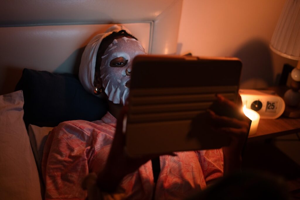 man texting smartphone night bed
