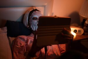 man texting smartphone night bed
