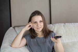 single mother smiling smartphone night living room