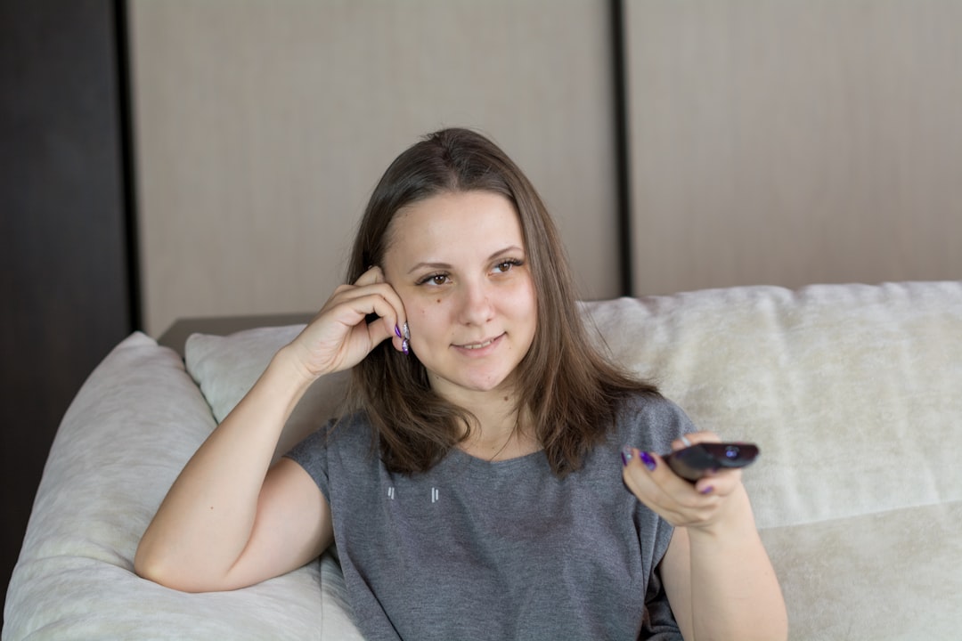 single mother smiling smartphone night living room