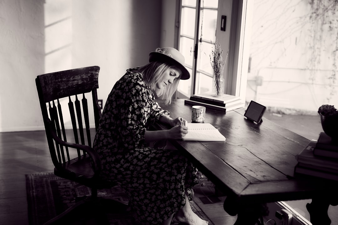 woman writing profile cafe