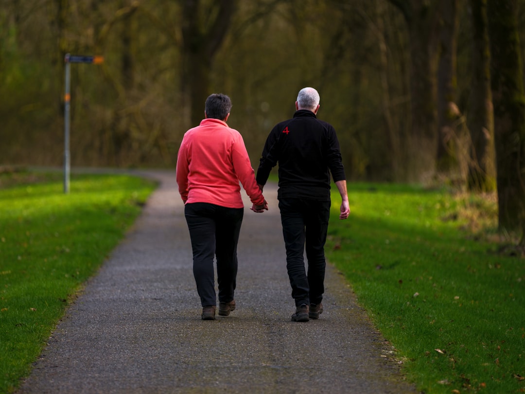happy couple 40s walking park