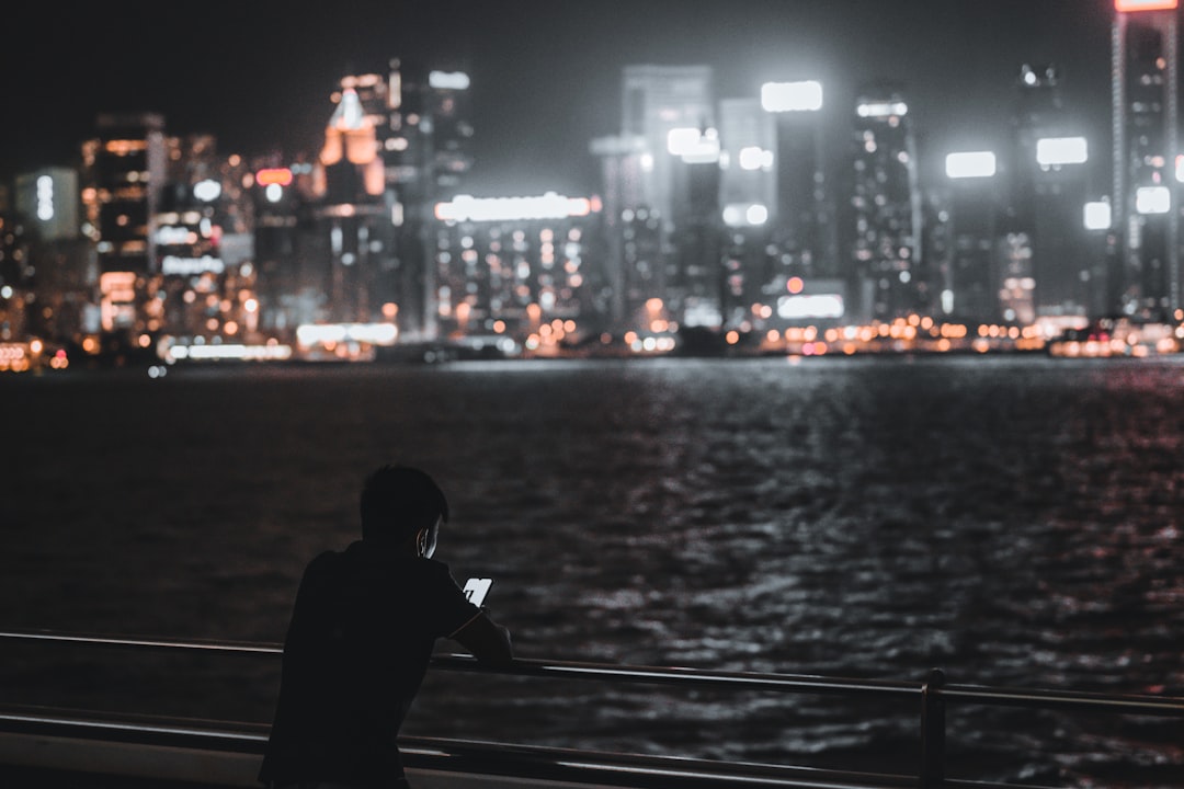 lonely man smartphone night city
