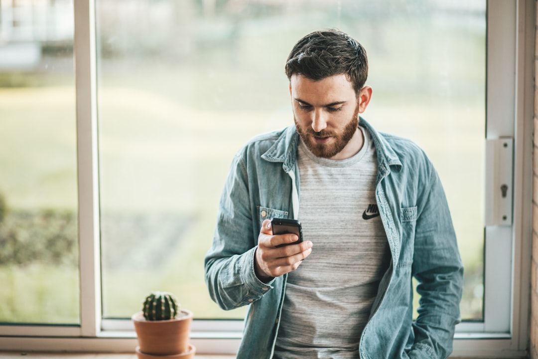 man typing phone message