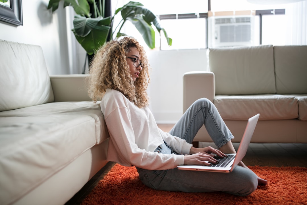 young woman researching online laptop home