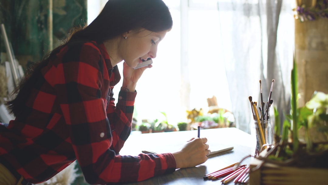 japanese woman writing notebook smartphone