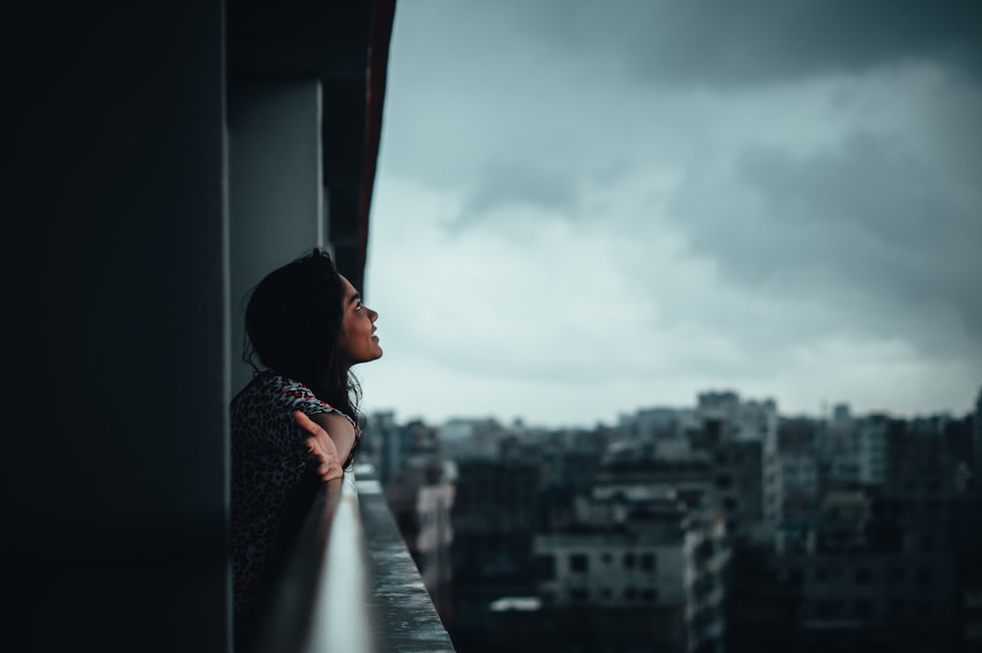 thoughtful woman window rain