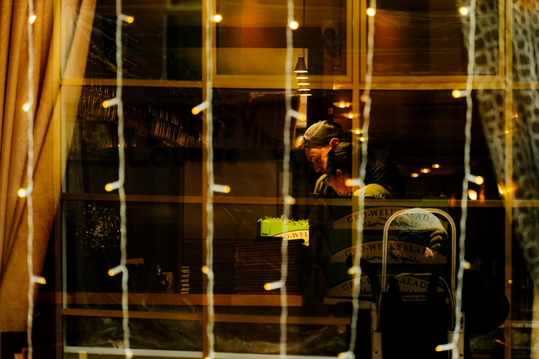 man looking at phone cafe night