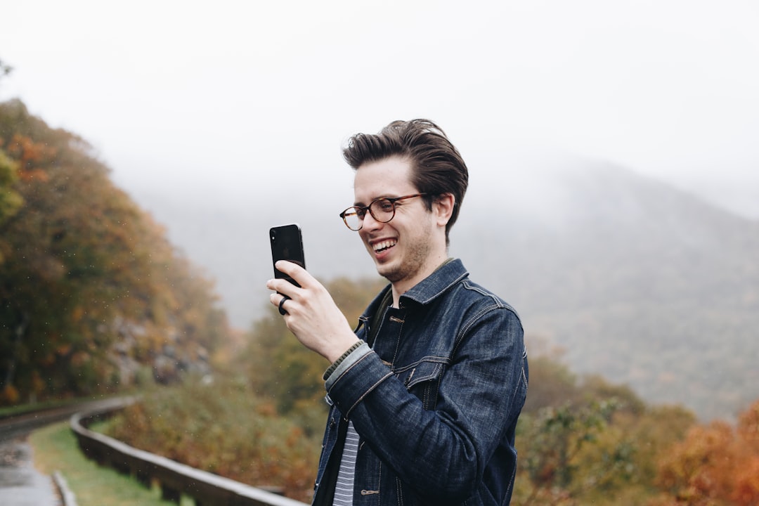 happy man using smartphone dating app