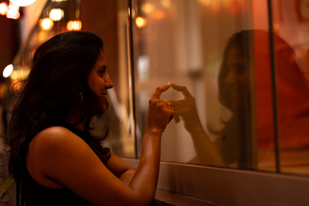 smiling woman engagement ring window