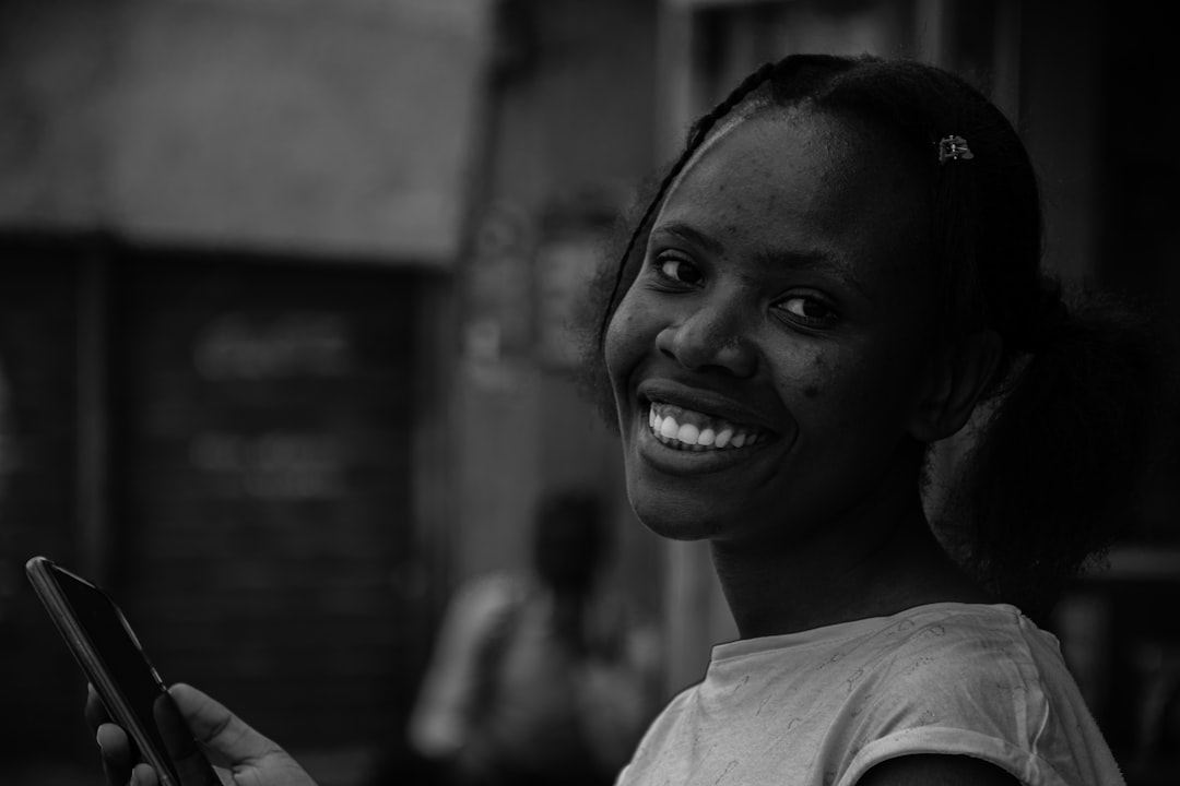 woman smiling smartphone window light