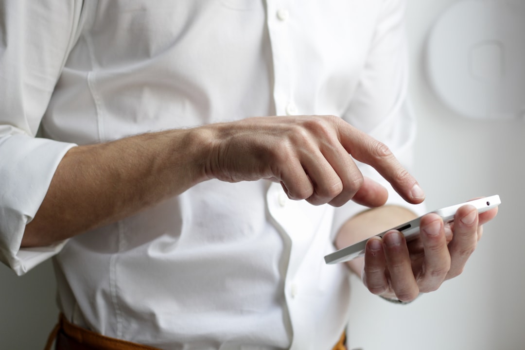 man managing multiple smartphone apps