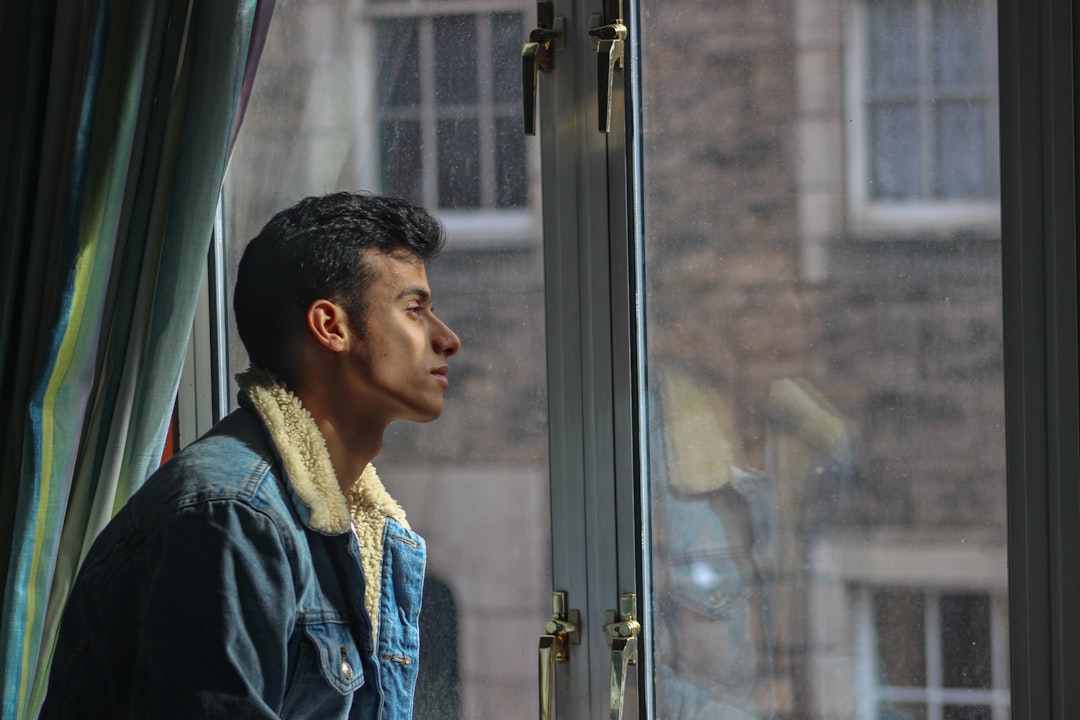 calm man relaxing window