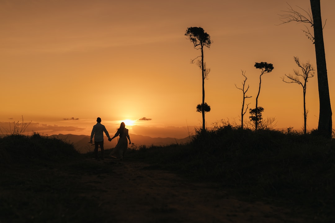 happy couple holding hands sunset