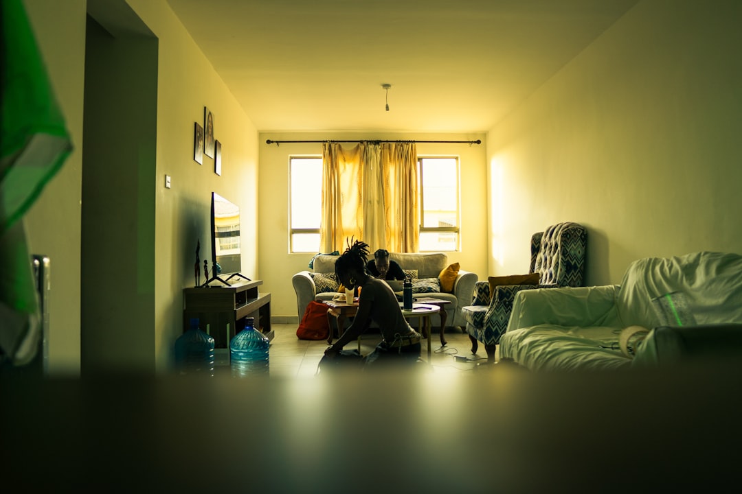 single mother using smartphone at night living room