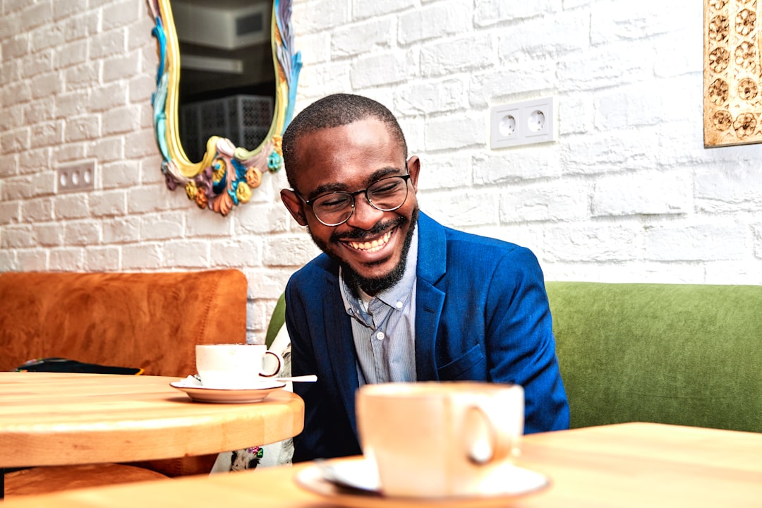 man listening smiling conversation cafe