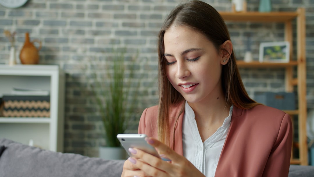 woman relaxed checking phone at home