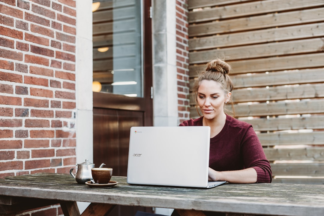 woman writing profile laptop smiling